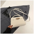Elegant cream white lychee pattern leather trapezoid Kelly handbag on a grey suit jacket - Off White