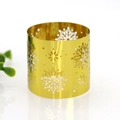 Detailed close-up of golden snowflake cutout metal napkin ring for hotel table setting - Mirror Gold
