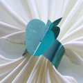 Teal metallic apple napkin ring with a pearl finish on a white silk napkin decoration - 17.5cm / Mirror Indigo