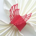 Detailed macro view of laser-cut red paper napkin ring with elegant wing design on satin - Pearlescent Red