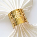Elegant gold glitter snowflake napkin ring on a white satin fabric for Christmas decor - Sparkling Gold