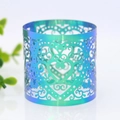 Macro detail of laser-cut heart pattern on iridescent blue-green napkin ring - Rainbow Blue