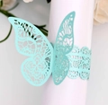 Detail of laser-cut butterfly napkin ring in mint green with intricate hollow patterns - Tiffany Blue