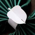 Macro view of white laser-cut paper napkin rings with elegant leaf design for weddings - White