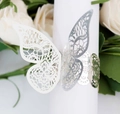 Macro view of gold lace butterfly napkin ring with laser-cut hollow pattern for weddings - Reflective Silver