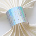 Detail of laser-cut snowflake napkin ring with iridescent pearl finish on white cloth - Mirror Iridescent
