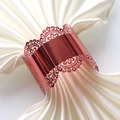 Close-up of rose gold lace hollow napkin ring on a cream silk napkin for wedding decor - Mirror Apple Red
