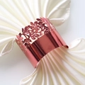 Close-up of rose gold hollow leaf napkin ring on elegant white satin fabric - Mirror Apple Gold