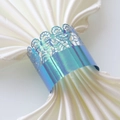 Close-up of holographic laser-cut crown napkin ring with blue gradient finish - Rainbow Blue