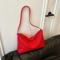 Vibrant red pebbled leather tote bag with long shoulder straps on a black sofa - Red (No Pendant)