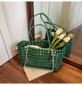 Forest green woven tote bag with cream drawstring liner on warm wooden floor - Green