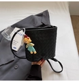 Détail d'un sac seau en cuir tressé noir avec une poupée et une chaîne de perles - Noir (Avec Pendentif)