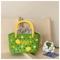 Detail view of a green EVA bath basket with yellow handle and a cotton drawstring liner - Green