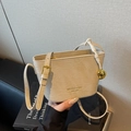 Chic beige crocodile texture bucket bag with gold heart pendant and adjustable strap - Khaki