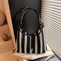 Striped black and white mesh bucket bag with leather shoulder strap and metal ring detail - Black