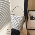 Chic silver quilted bucket bag with metallic finish and metal stud details - Silver