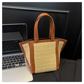 Detail of a structured woven straw tote bag with brown leather contrast and dual handles - Brown