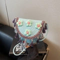 Light blue hand-woven crochet bucket bag with 3D floral accents and colorful fringe tassels - Blue