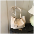 Minimalist beige lychee grain leather tote bag with slim handles and matching pendant charm - White
