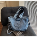 Blue denim tote bag with embossed star and mini coin purse in a cozy home setting - Light Blue