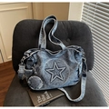 Detail of blue denim tote bag with star patch and small coin purse on a striped chair - Vintage Blue