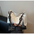 Detail of jacquard fabric patterns and wooden bead handle on the stylish tote bag - Gray