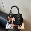 Elegant black woven leather handbag with woven handle and colorful pegasus charm - With Charm / Black
