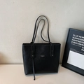 Minimalist black tote bag in lychee texture leather with slim straps and brand label - Black (No Charm)