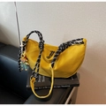 Detail of yellow canvas crescent bag with thick black and white woven rope handle - With Charm / Yellow