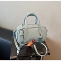 Close-up of light blue lychee pattern leather boston bag with silver lock detail - Blue