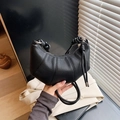 Minimalist black croissant shoulder bag in lychee texture with knot handle detail - Black
