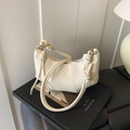 Chic cream dumpling shoulder bag with lychee grain leather and knot detail design - Off White