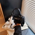 Retro black barrel handbag in shiny patent leather with pearl lace bow detail - Black