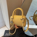 Mini yellow Boston bag in premium lychee leather with silver padlock and shoulder strap - Yellow