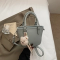 Minimalist mint green lychee pattern bucket bag with cute plush bear charm on white fabric - Blue with Charm