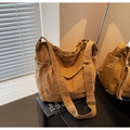Detail of yellow denim tote bag side pocket with distressed edges and metal buckle - Brown