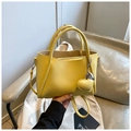 Bright yellow pebbled leather handbag with heart pendant and adjustable shoulder strap - With Charm / Yellow