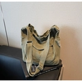 Detail of army green canvas hobo bag showing raw edge texture and wide adjustable strap - Green