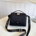 Minimalist black nylon crossbody bag with double zipper and adjustable strap on marble surface - Black Small