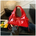 Detail of red pleated handbag featuring bow decorations and shiny synthetic leather - Red