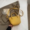 Yellow pebble grain leather bucket bag with silver hardware on a green blazer - Yellow Without Pendant