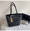 Detail of black geometric tote bag with silver bow accent and cute cartoon charm - Black with Pendant
