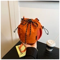 Detailed view of an orange nylon bucket bag featuring a drawstring closure and mesh side pocket - Orange