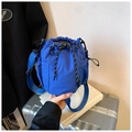 Blue nylon drawstring bucket bag with mesh side pocket and colorful decorative cords - Blue