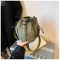 Detail of army green nylon bucket bag featuring drawstring closure and side mesh pocket - Dark Green