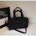 Minimalist black yoga fitness bag with adjustable shoulder strap and silver hardware detail - Black