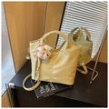 Sage green crocodile-embossed bucket bag with plush dog charm and adjustable strap - Yellow with Pendant