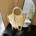 Pale yellow crossbody bucket bag with round handle and pink ribbon heart pearl charm - White with Pendant