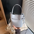 Light blue bucket bag with drawstring closure and crossbody strap in leather texture - Blue