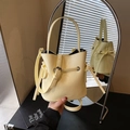 Minimalist cream yellow bucket handbag for women with top handle and crossbody strap - Yellow